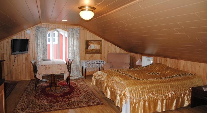 a bedroom with a bed and a window and a television at Sininen Talo in Naantali