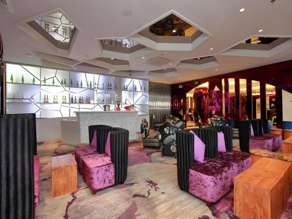 a room with purple chairs and tables in a store at Harbin Ju Jian Hotel in Harbin