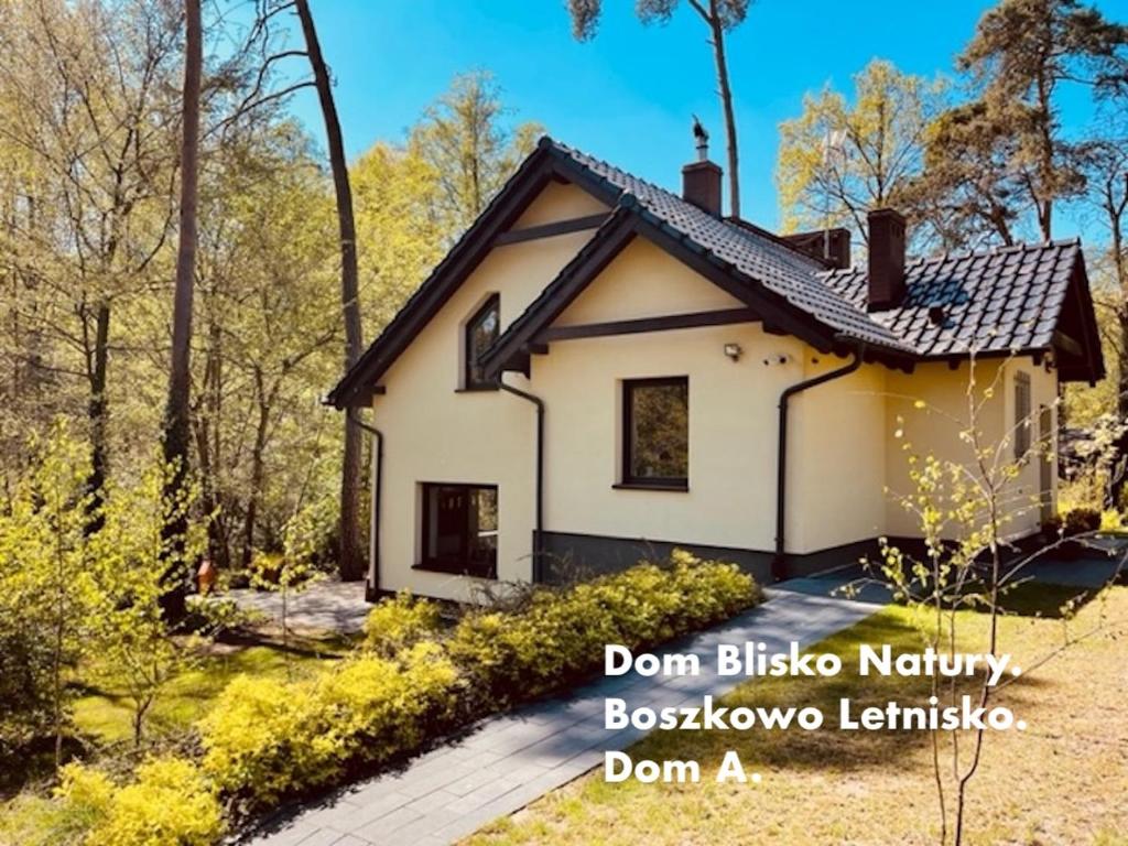 a small house in the woods with the words dont bilbia norbia bosowe at Dom Blisko Natury Boszkowo Letnisko Dom A in Boszkowo-Letnisko