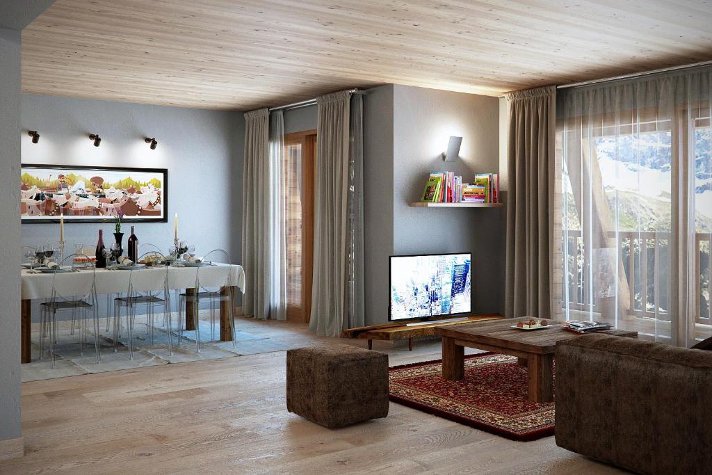 a living room with a couch and a tv and a table at Aux Pieds du Roi - Suite & Spa in Breuil-Cervinia