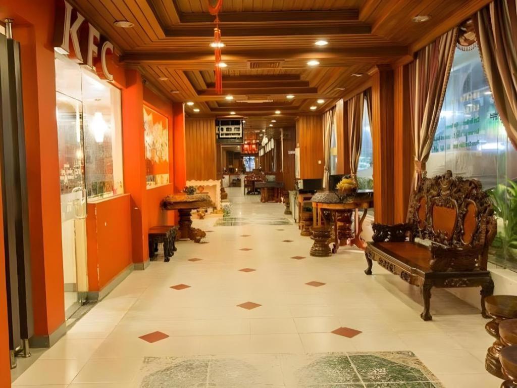 a hallway with chairs and tables in a building at Asia Hotel in Phnom Penh