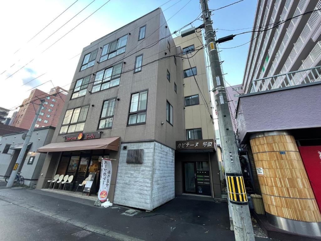 a building on the corner of a city street at カピテーヌ琴似 in Sapporo