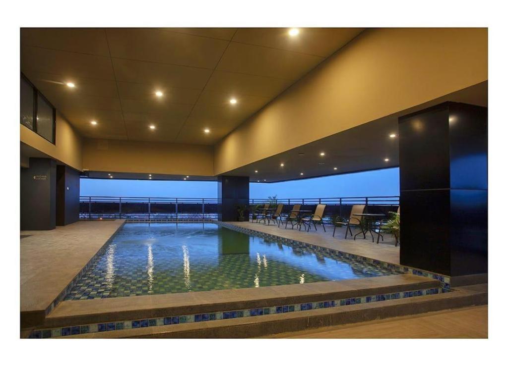 a swimming pool in the middle of a building at The Bono Hotel Pekanbaru in Pekanbaru