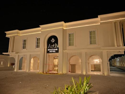 a large white building with a sign on it at Arth Boutique and Hotel in Kota