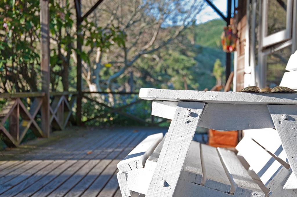 a cat sitting on top of a white bench at The Cottage in Wairoa
