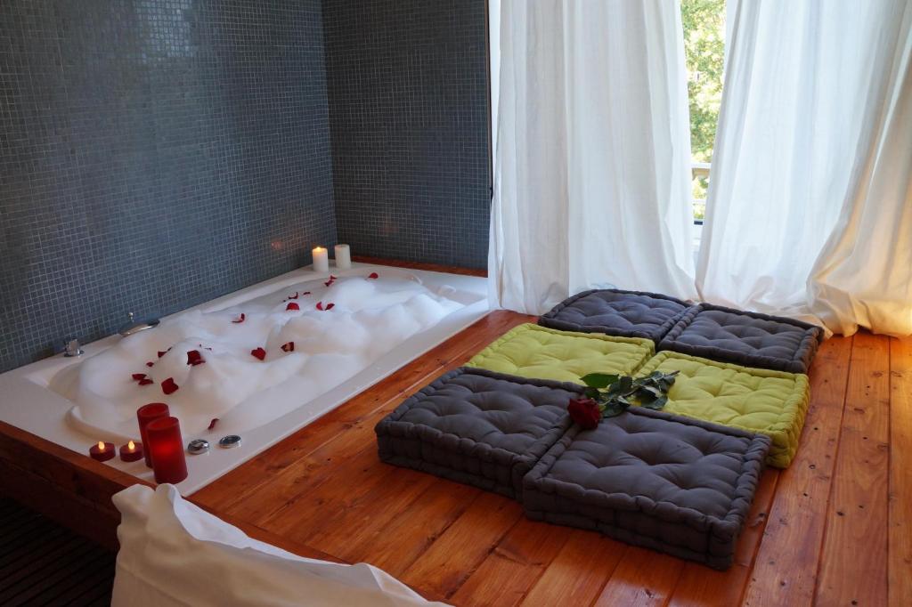 a bath tub with a bed in the middle of a room at Jacuzzi Rooms in Rome