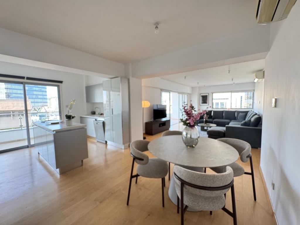 a living room and kitchen with a table and chairs at Home in Central Nicosia - Spacious Balcony in Nicosia