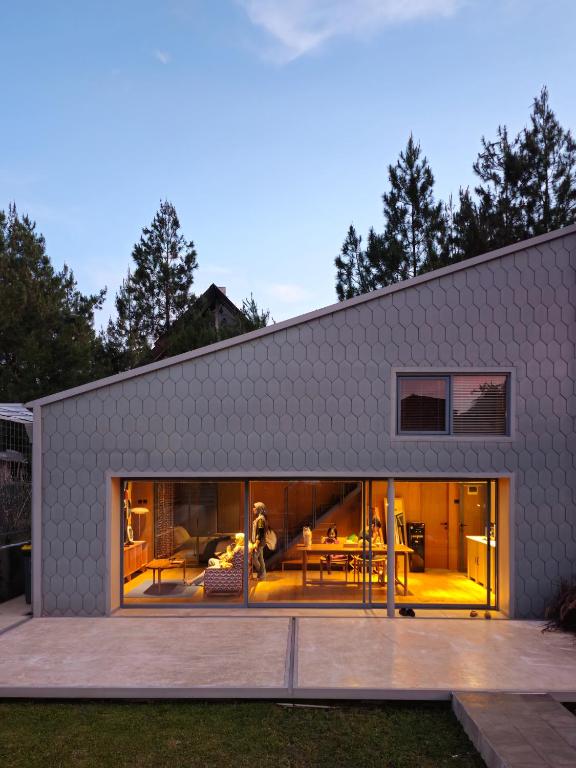a house with large glass doors and a patio at Villa Cannary in Tegalharendong