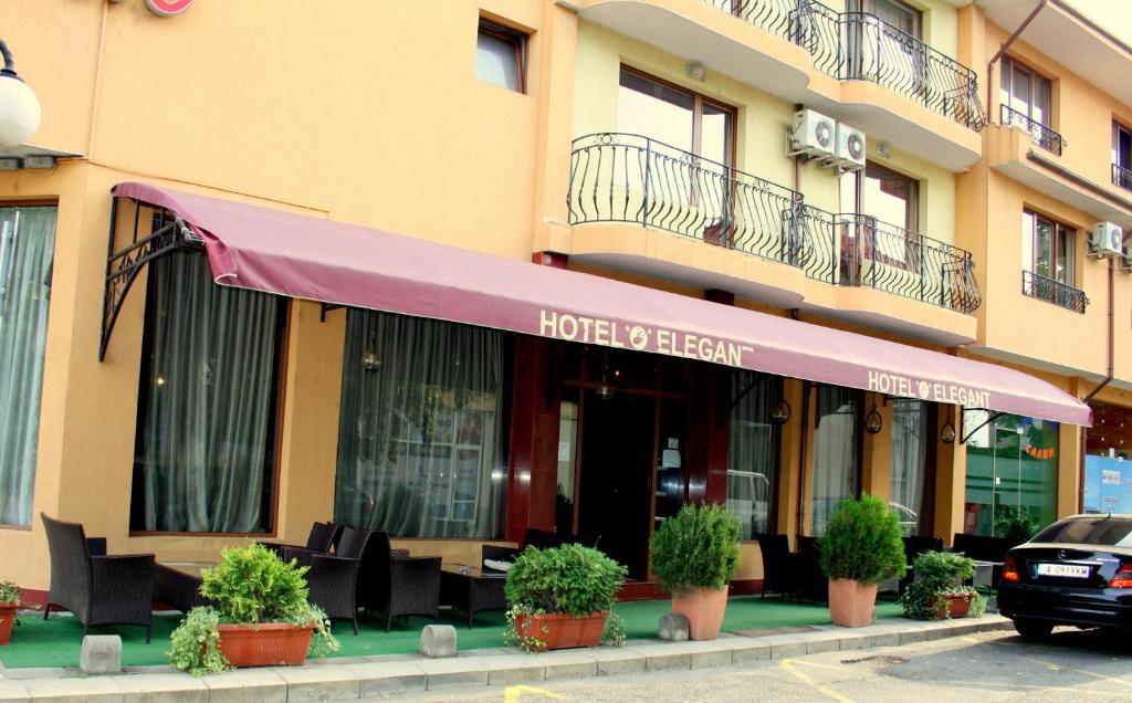 a hotel with a purple awning in front of a building at Hotel Elegant in Karnobat