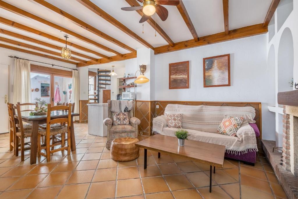 a living room with a couch and a table at Casa El Valle Verde Granada in Lecrin