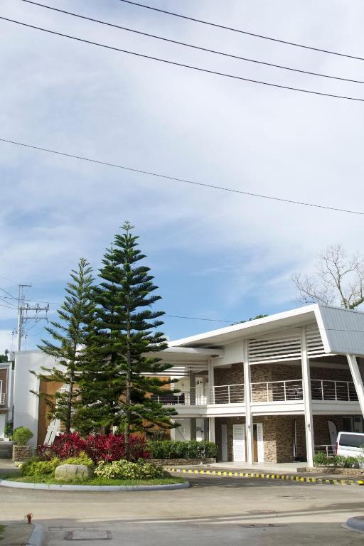 a building with a tree in front of it at Verdant Villas in Kaybagal