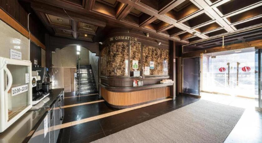 a restaurant with a bar in the middle of a room at Yongin Valentine in Tansa-gol