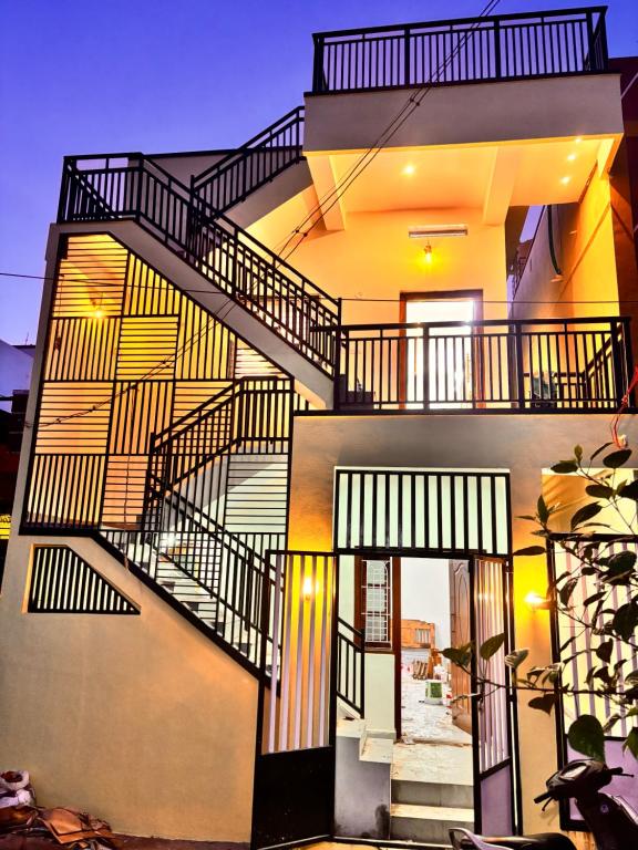 a building with stairs on the side of it at Rajkamal Hampi in Hospet