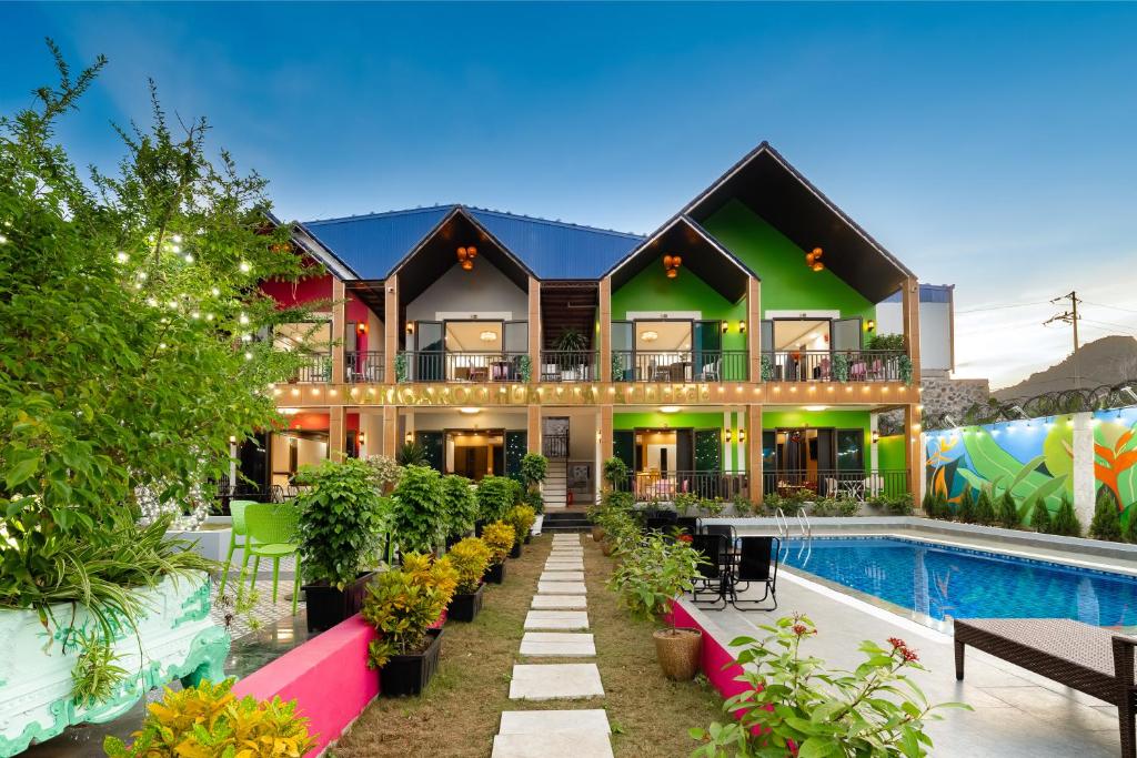 a house with a swimming pool and a resort at Kangaroo homestay in Cat Ba