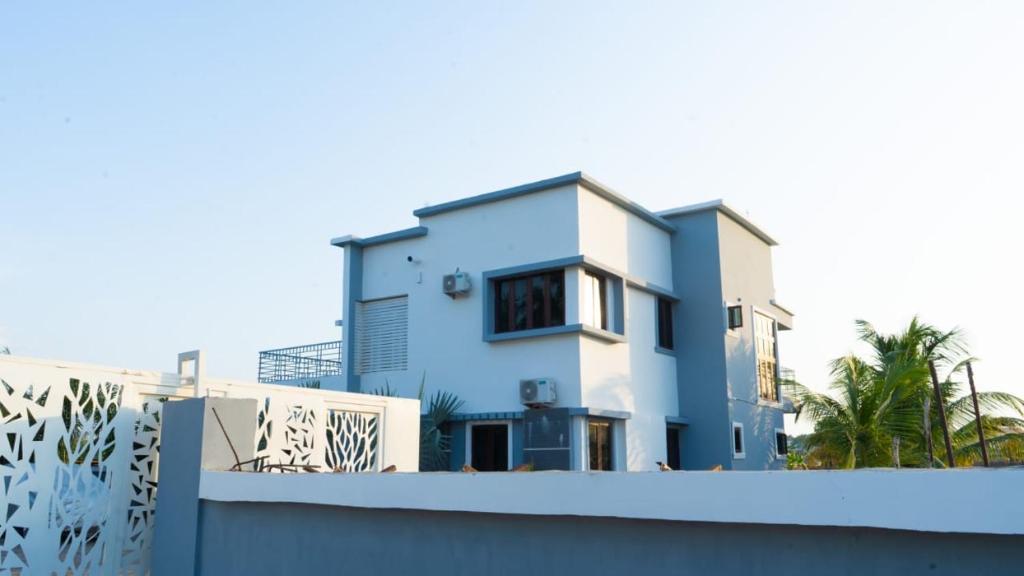 a blue and white house with a fence at Camp Ground 