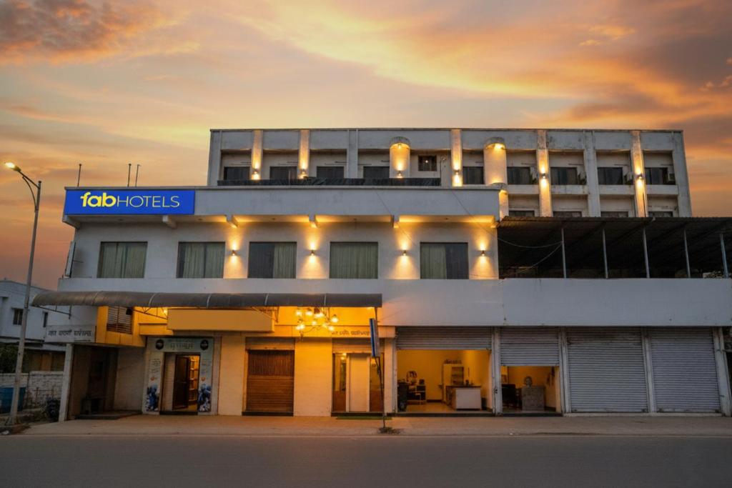 a building with a sign on the front of it at FabHotel Devanshi Inn in Kalamboli