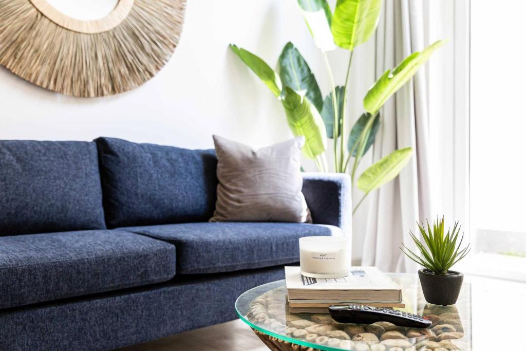 a blue couch in a living room with a coffee table at Relaxed, Spacious & Ideal for Small Families in Bournemouth