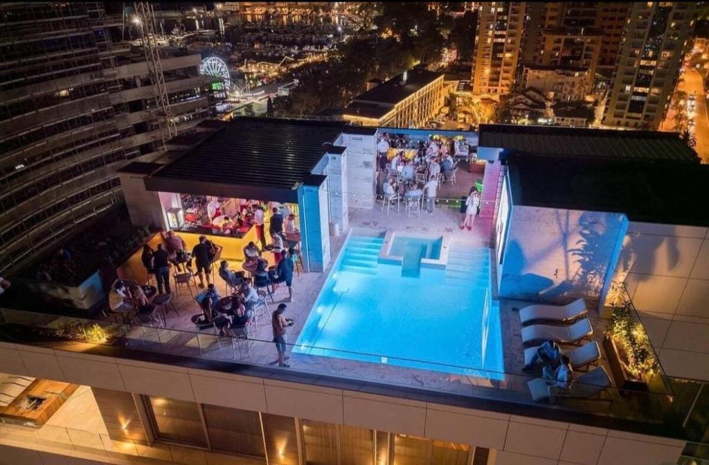 a group of people standing around a pool on a building at Budva Wow 503 in Budva