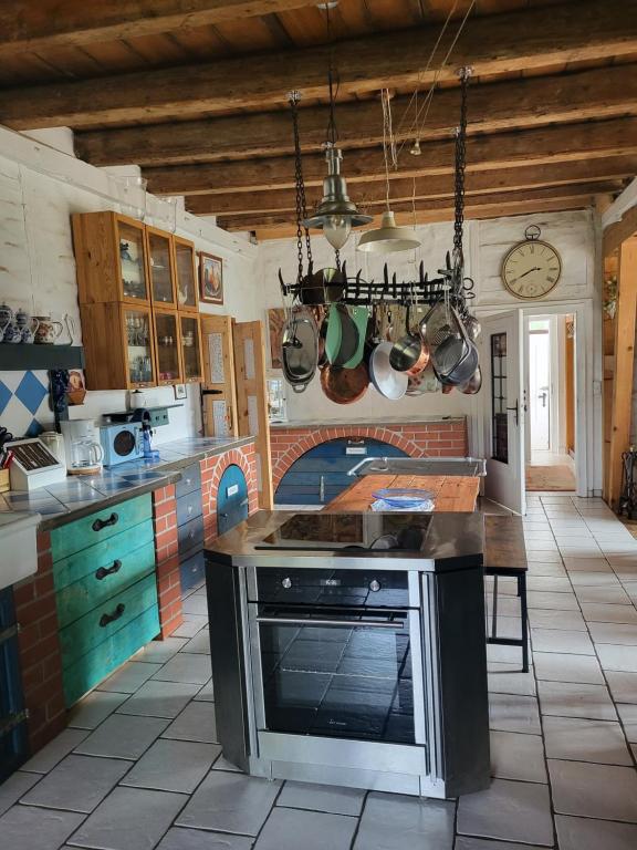 a kitchen with a stove top oven in a room at Ferienwohnung Sieg in Mittelhof