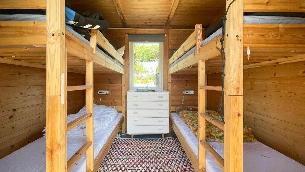 a bedroom with two bunk beds in a log cabin at Original Architecture In Southern Norway in Søndeled