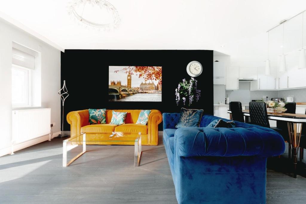 a living room with two couches and a table at 4-BR House Near-Harry Potter-SkyStudios1-Family & Work Stays in Borehamwood