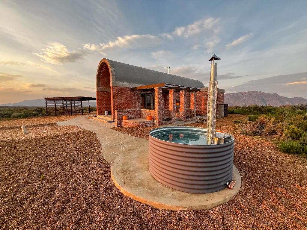 a house with a pool in the middle of a field at Windvogels in Barrydale