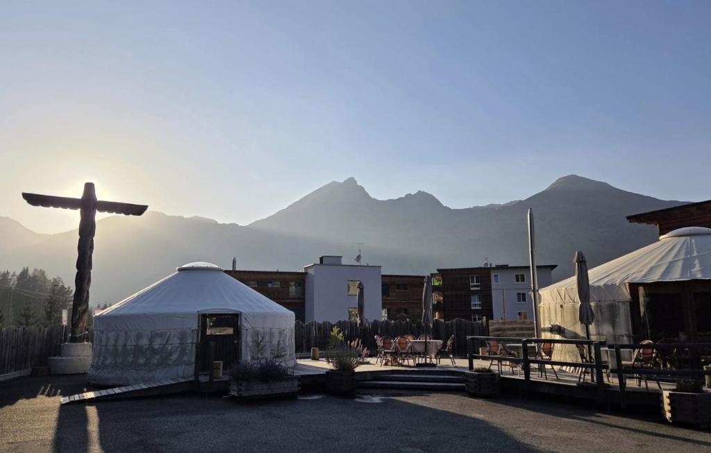 a church with a cross in front of a mountain at Shima-Davos in Davos