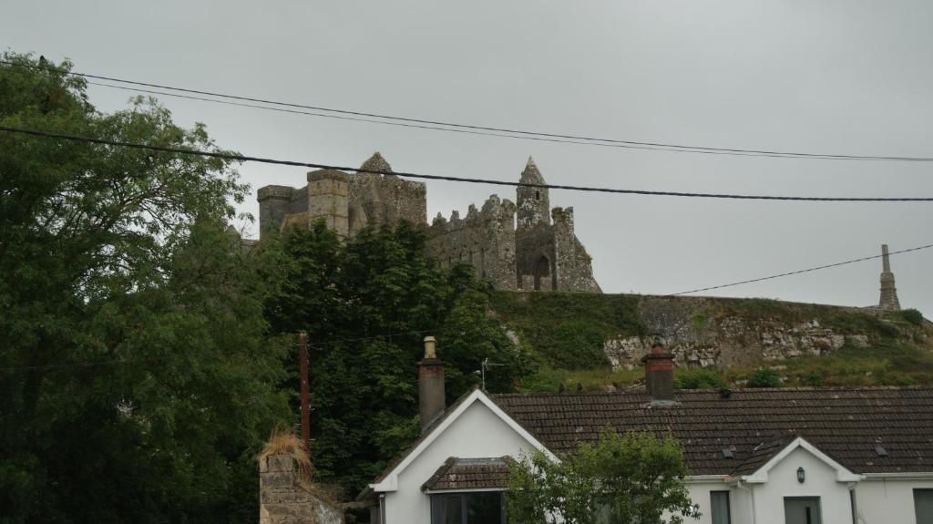 a castle on top of a hill with houses at Rockville in Cashel
