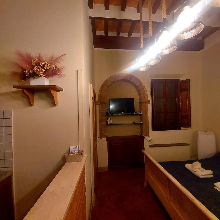 a room with a bathroom with a sink and a toilet at QUERCECCHIO Relax in San Gimignano