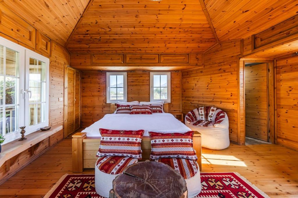 a bedroom with a bed in a wooden cabin at The Animals Farm Double Room in Tirana
