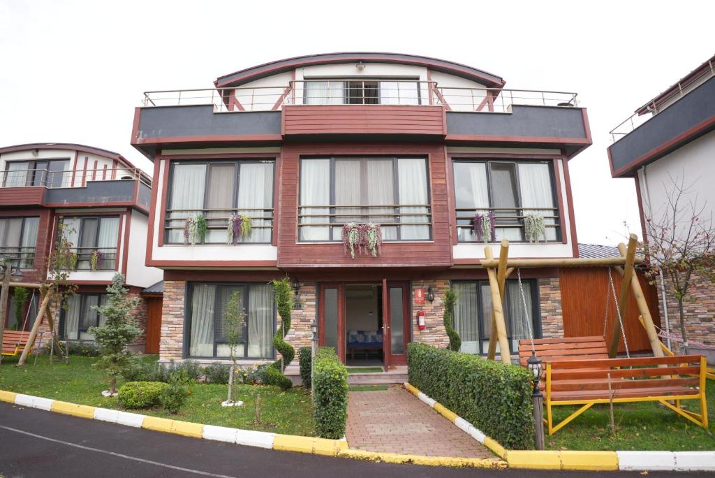 a red brick house with a bench in front of it at HK Resort 