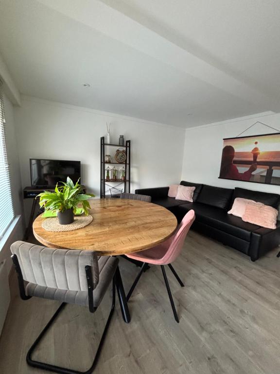 a living room with a table and a couch at ChezPetitOscar in Middelkerke