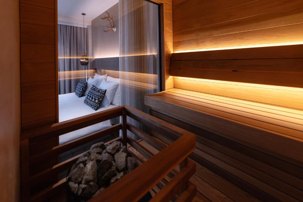 a room with a sauna with a bed in it at Lapland Hotels Oulu in Oulu