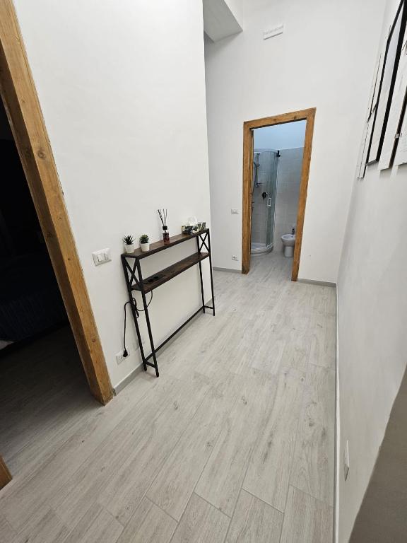 an empty room with a table and a hallway at Al Vecchio Orologio in Viterbo