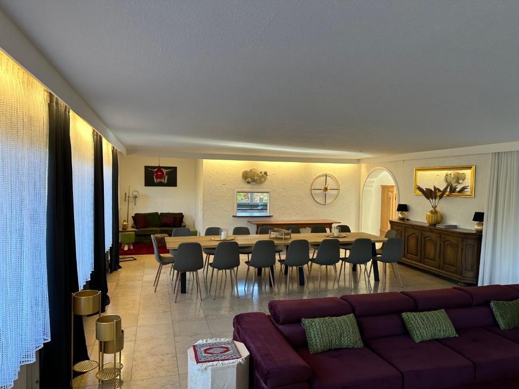 a living room with a couch and a table and chairs at Haus Anna in Alpirsbach