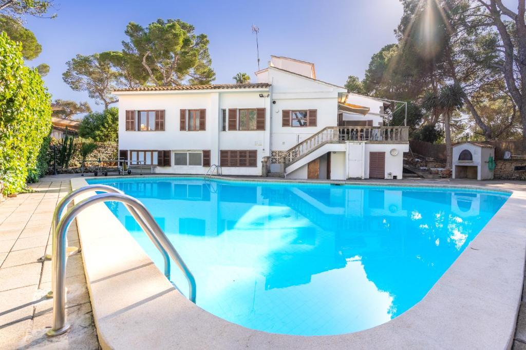a swimming pool in front of a house at Villa Ribera de Son Veri in El Arenal
