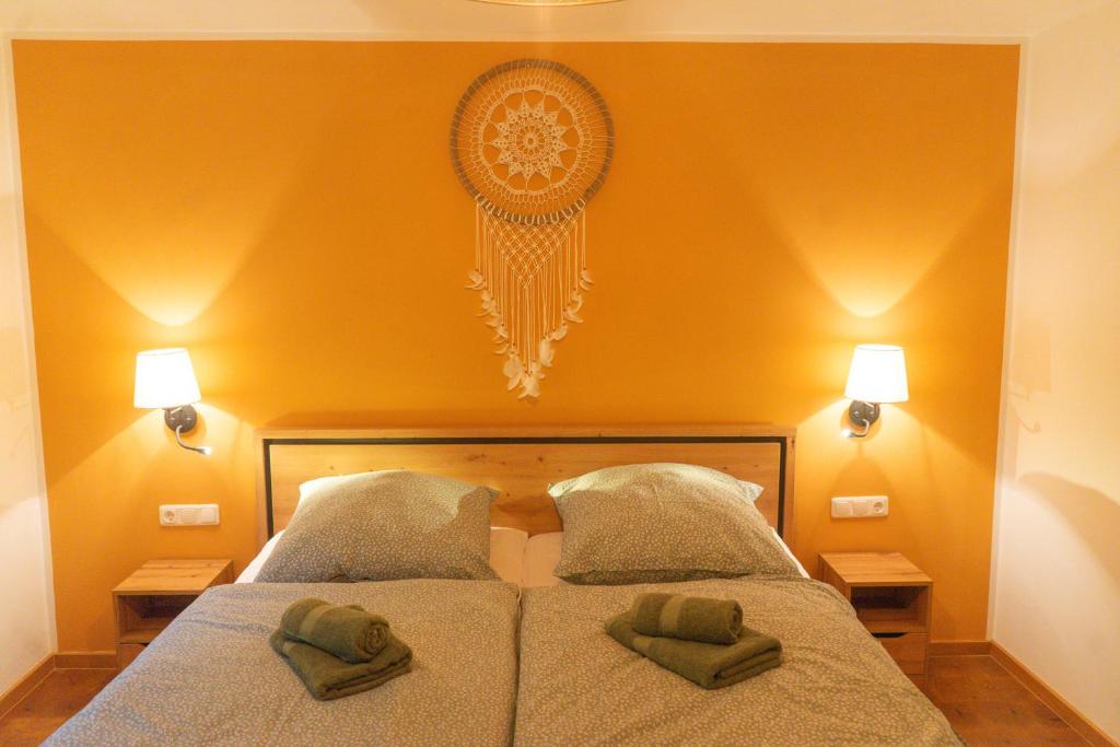 a bedroom with a bed with two green pillows on it at Apartment Erde im Ferienhaus am Waldbach in Kirchzell