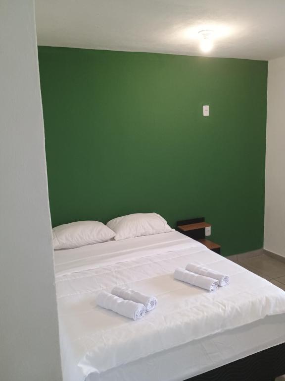 Ένα ή περισσότερα κρεβάτια σε δωμάτιο στο Sana Suítes