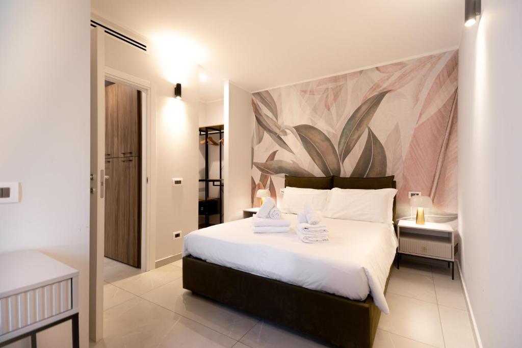 a bedroom with a large bed with a painting on the wall at Home Manu Luxury Como Lake in Como