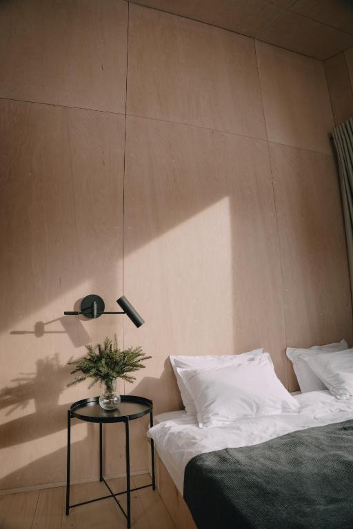 a bedroom with two beds and a table with a lamp at Barnhouse Tatariv in Dobrovelychkivka