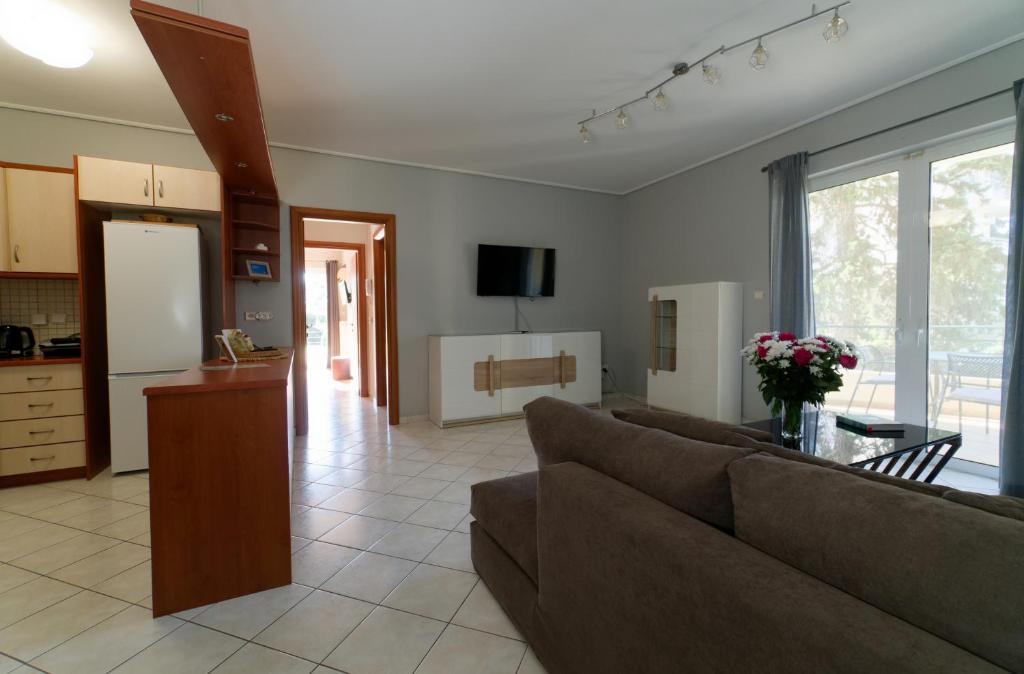 a living room with a couch and a table at Cozy & Relaxing Apartments-Agia Paraskevi in Athens