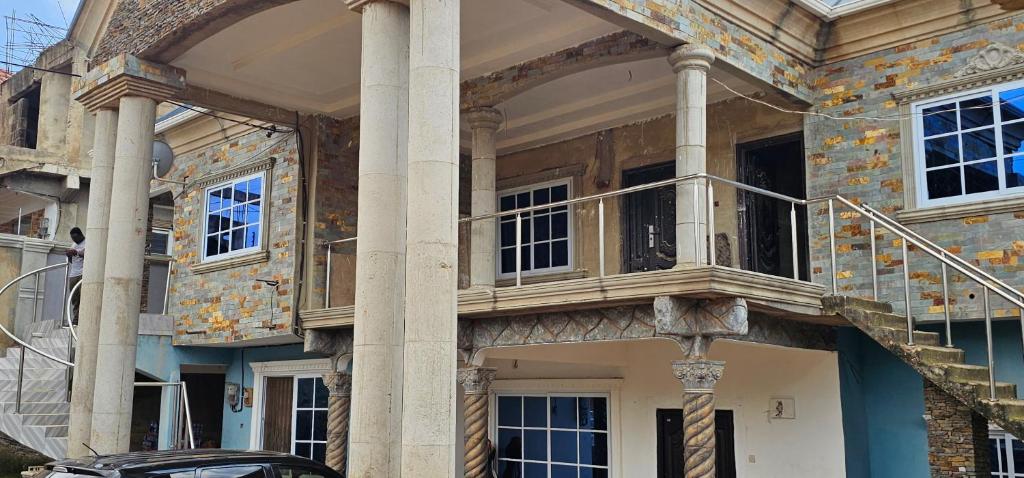 a building with columns and a balcony on it at GV Homes and Apartments in Gbawe