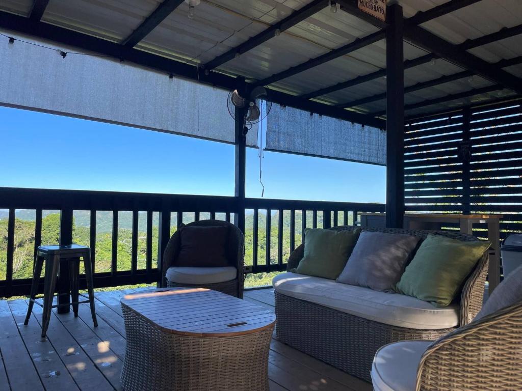 a screened in porch with a couch and a table at Doa Blanca Cabin Mountain View in Utuado