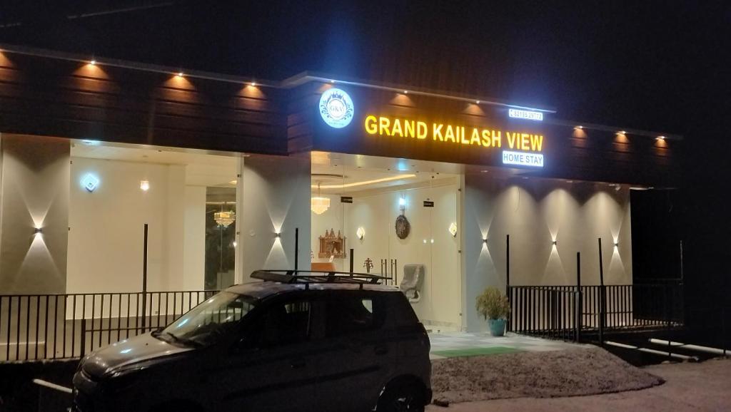 a car parked in front of a grand malaysia way building at night at Grand Kailash Khajjiar in Dalhousie