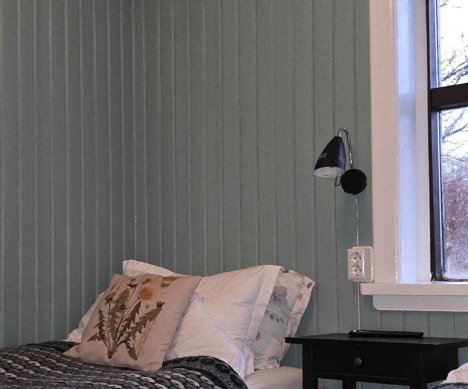 um quarto com uma cama, um candeeiro e uma mesa em Prestshús 2 Guesthouse em Vík