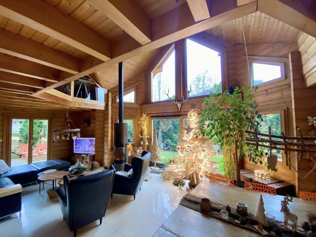a living room with a blue couch and a table at Villa Aurora in Orbey