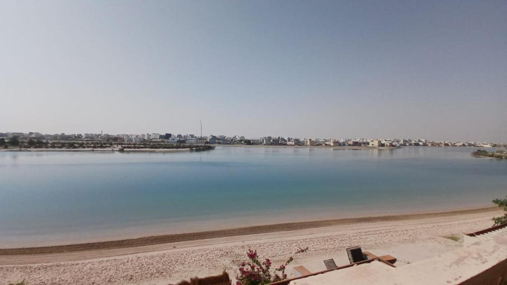 a view of a body of water with a beach at Zayed chalet for families in Al Khīrān