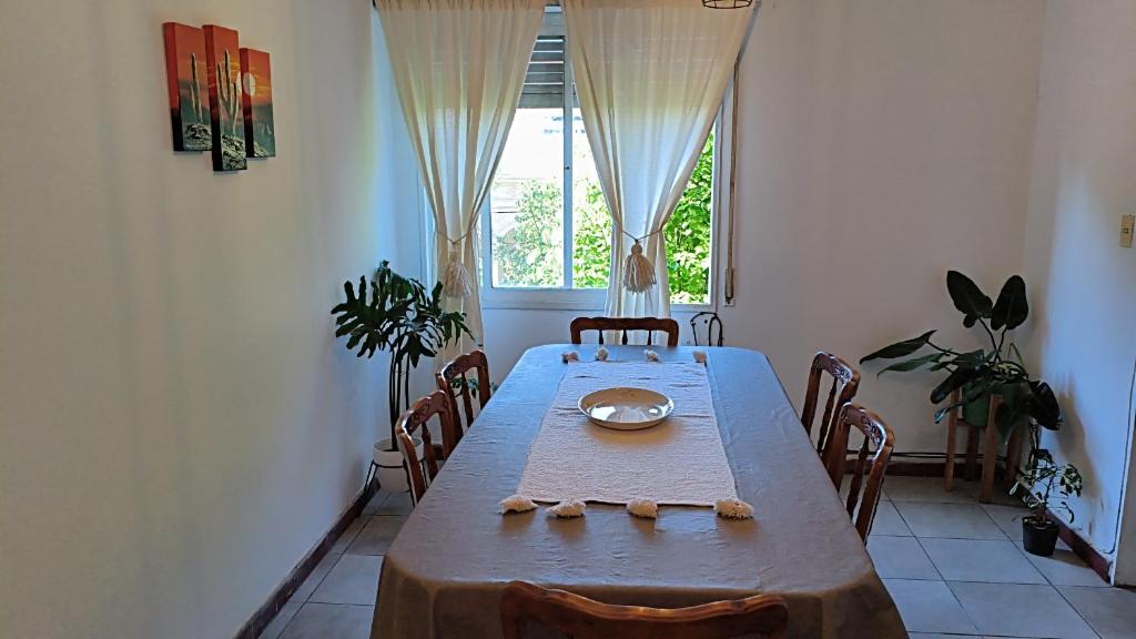 a dining room with a table and a window at Altos Jujuy 2 in San Salvador de Jujuy