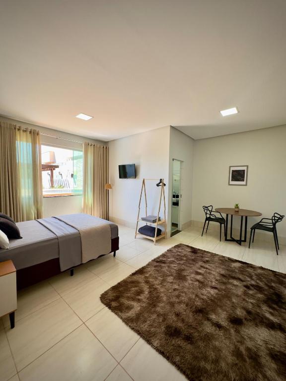 a bedroom with a bed and a table in it at Rancho Palmeira Jardim in Formosa