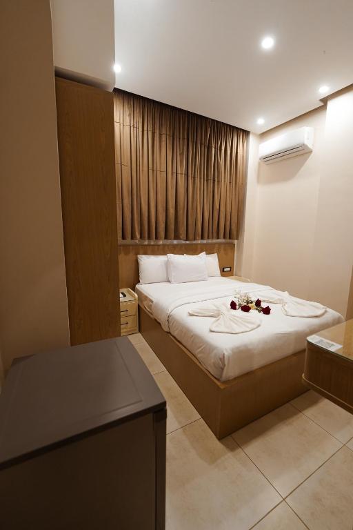 a hotel room with a large bed with flowers on it at KASTELLO hotel in Cairo